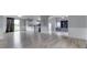 Spacious living room and eat-in kitchen features wood-look floors, neutral walls, and access to the backyard at 5964 N Pr Wind Drift Ln, Shelbyville, IN 46176