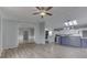 Spacious living room with view of eat-in kitchen, wood-look floors, and neutral paint throughout at 5964 N Pr Wind Drift Ln, Shelbyville, IN 46176