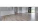 Bright living room features wood-look floors, neutral walls, and a sliding glass door for easy outdoor access at 5964 N Pr Wind Drift Ln, Shelbyville, IN 46176