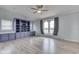 Bright living room features built-in cabinets, modern windows, and wood-look floors with neutral walls at 5964 N Pr Wind Drift Ln, Shelbyville, IN 46176