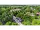 Aerial view shows a property with lush trees, a detached garage, and a charming home at 6029 English Ave, Indianapolis, IN 46219