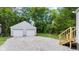 Backyard features a stone driveway, a detached two-car garage, and a newly built staircase at 6029 English Ave, Indianapolis, IN 46219