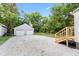 Backyard features a stone driveway, a detached two-car garage, and a newly built staircase at 6029 English Ave, Indianapolis, IN 46219