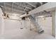 This basement features painted walls, ceilings, support beams, and a staircase at 6029 English Ave, Indianapolis, IN 46219