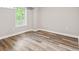 Bedroom featuring wood-look flooring and a bright window at 6029 English Ave, Indianapolis, IN 46219