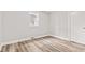 Bedroom features a window and wood-look flooring at 6029 English Ave, Indianapolis, IN 46219