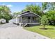 Inviting home featuring a covered porch and gravel driveway at 6029 English Ave, Indianapolis, IN 46219