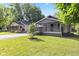 Charming home with inviting front yard and two-tone neutral color scheme at 6029 English Ave, Indianapolis, IN 46219