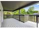 Covered front porch with painted wood flooring and railing detail at 6029 English Ave, Indianapolis, IN 46219