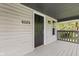 Covered front porch showcasing home number and neutral color scheme at 6029 English Ave, Indianapolis, IN 46219
