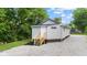 Exterior view features stone driveway, newly built stoop, and vinyl siding at 6029 English Ave, Indianapolis, IN 46219