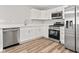Modern kitchen with stainless steel appliances and white cabinets at 6029 English Ave, Indianapolis, IN 46219