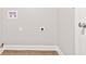 Neutral laundry room features hookups, painted walls, white trim, and wood-look vinyl flooring at 6029 English Ave, Indianapolis, IN 46219