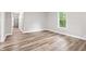 Living room boasting a modern kitchen, light gray walls, and wood-look flooring at 6029 English Ave, Indianapolis, IN 46219