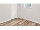 Finished room boasts luxury vinyl floors, white paint, white trim, and a double hung window at 6029 English Ave, Indianapolis, IN 46219