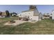Spacious backyard with fire pit, patio, seating area and manicured lawn at 6214 Weller Cir, Indianapolis, IN 46268