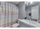 Bathroom with decorative shower curtain, mosaic tile, and white sink at 6214 Weller Cir, Indianapolis, IN 46268