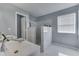 Bathroom with double sinks, walk-in shower, and white tile at 6214 Weller Cir, Indianapolis, IN 46268