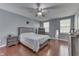 Bedroom with hardwood floors, a ceiling fan, and natural light from two windows at 6214 Weller Cir, Indianapolis, IN 46268