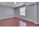 Bedroom with hardwood floors, natural light, and a calming neutral wall color at 6214 Weller Cir, Indianapolis, IN 46268