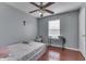 Bedroom with hardwood floors, ceiling fan, and natural light from the window at 6214 Weller Cir, Indianapolis, IN 46268