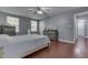 Bedroom with hardwood floors, a ceiling fan, and natural light from two windows at 6214 Weller Cir, Indianapolis, IN 46268