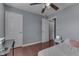 Bedroom featuring hardwood floors, a ceiling fan, and a small desk at 6214 Weller Cir, Indianapolis, IN 46268