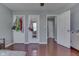 Bedroom view of hardwood floors, closet, and view to another room at 6214 Weller Cir, Indianapolis, IN 46268