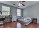 Bedroom features hardwood floors, a ceiling fan, and natural light from the two windows at 6214 Weller Cir, Indianapolis, IN 46268