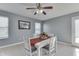 Cozy dining room featuring a decorative ceiling fan, neutral paint, and a sliding glass door at 6214 Weller Cir, Indianapolis, IN 46268