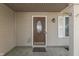 Close up of the front door, with an oval glass insert and decorative window and front porch at 6214 Weller Cir, Indianapolis, IN 46268