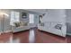 Bright living room with hardwood floors, comfortable seating, and a view of the staircase at 6214 Weller Cir, Indianapolis, IN 46268