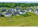 Aerial view showcases many gray and white homes with manicured lawns and landscaping in a suburban neighborhood at 633 Cowley Dr, Westfield, IN 46074