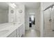 Bathroom with double sink vanity, neutral flooring, and glass shower at 633 Cowley Dr, Westfield, IN 46074