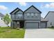 Two-story home with grey siding, a two car garage and a well manicured front lawn at 633 Cowley Dr, Westfield, IN 46074