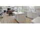 Open concept kitchen with island, stainless appliances, and hardwood floors at 633 Cowley Dr, Westfield, IN 46074
