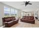 Bright living room featuring two leather couches, hardwood floors, and sun-filled windows at 633 Cowley Dr, Westfield, IN 46074