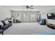 Bright living room with plush carpeting, ceiling fan, and natural light from three windows at 633 Cowley Dr, Westfield, IN 46074