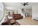 Open concept living room with hardwood floors leading to the kitchen and stairway at 633 Cowley Dr, Westfield, IN 46074