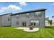 A well-maintained backyard featuring a patio with grill and seating, against the backdrop of the home's gray exterior at 633 Cowley Dr, Westfield, IN 46074