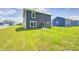 A well-maintained backyard featuring a lush lawn and a modern home with a cozy patio for outdoor enjoyment at 6332 Card Blvd, Indianapolis, IN 46221