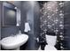 Stylish half-bathroom with modern sink and decorative floral wallpaper at 6332 Card Blvd, Indianapolis, IN 46221