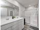 Bright bathroom featuring a double sink vanity with white cabinets and a glass-enclosed shower at 6332 Card Blvd, Indianapolis, IN 46221