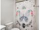 Bathroom featuring a toilet and a decorative shower curtain with a butterfly and celestial designs at 6332 Card Blvd, Indianapolis, IN 46221