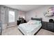 Stylized bedroom with a cozy bed and a vanity with lighted mirror for getting ready at 6332 Card Blvd, Indianapolis, IN 46221