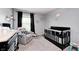 Bedroom with a dark crib, a comfy armchair, and soft lighting, creating a cozy space at 6332 Card Blvd, Indianapolis, IN 46221