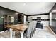 Dining area with a rustic wooden table and chairs, open to the kitchen with white cabinetry at 6332 Card Blvd, Indianapolis, IN 46221