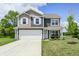 Inviting two-story home with a two-car garage, a cozy front porch swing, and a well-maintained front yard at 6332 Card Blvd, Indianapolis, IN 46221