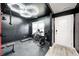 Home gym with workout equipment, rubber flooring, a modern lighting fixture and natural light at 6332 Card Blvd, Indianapolis, IN 46221