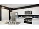 Modern kitchen features stainless steel appliances, white cabinets, and marble countertops for a sleek design at 6332 Card Blvd, Indianapolis, IN 46221